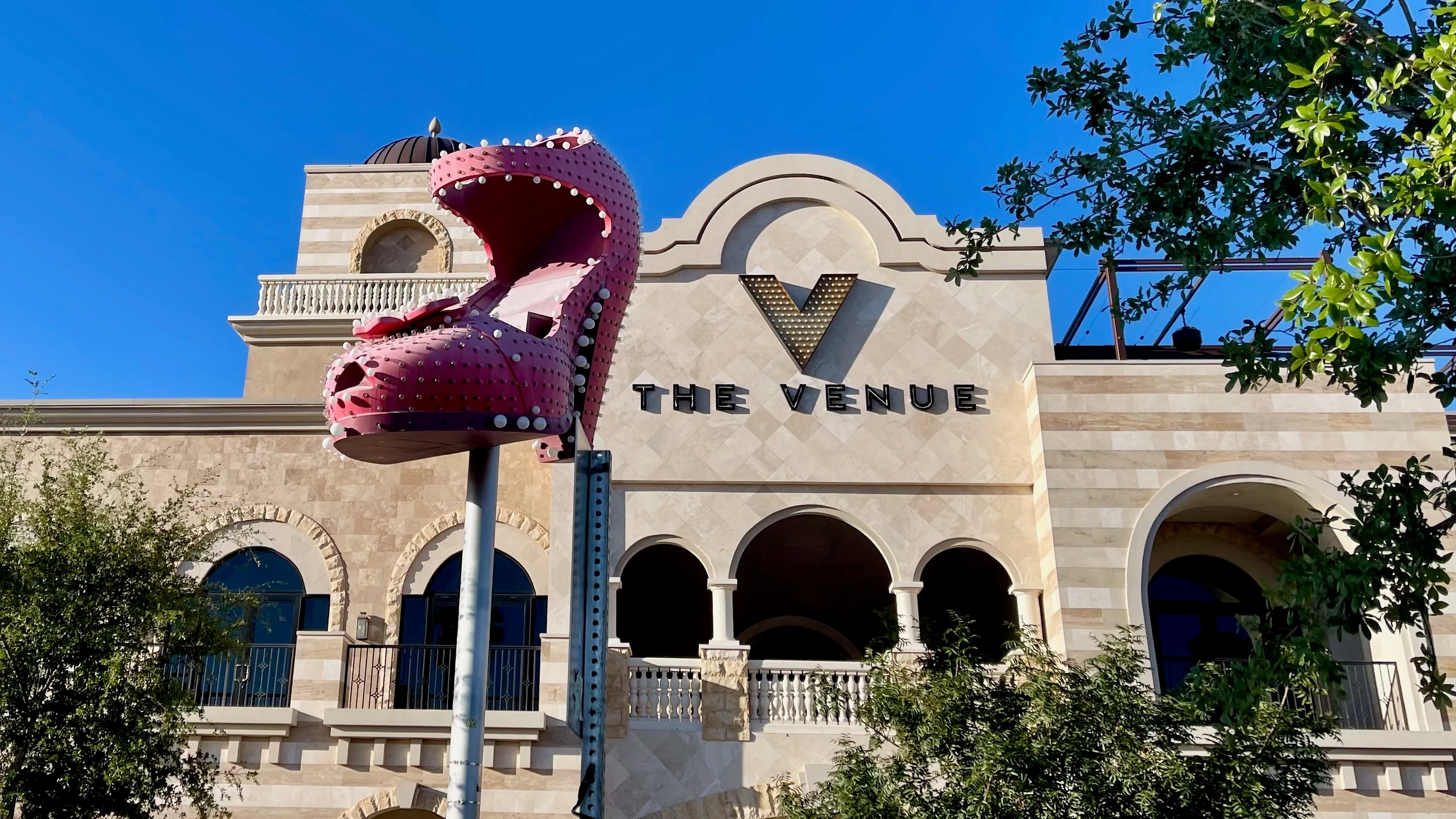 an art display of a giant pink high heeled shoe